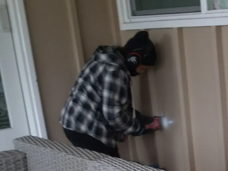 Professional electrician installing an exterior outlet in Waterloo